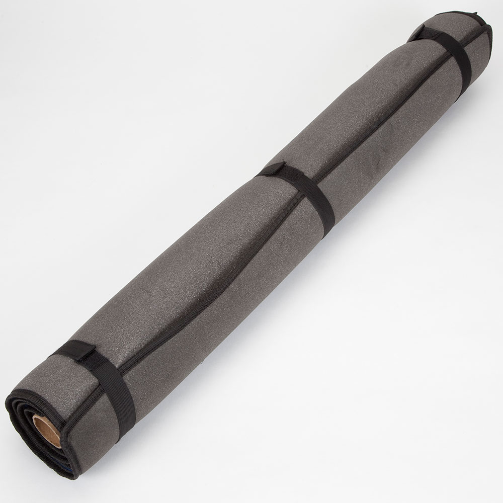A gray puzzle mat rolled up.